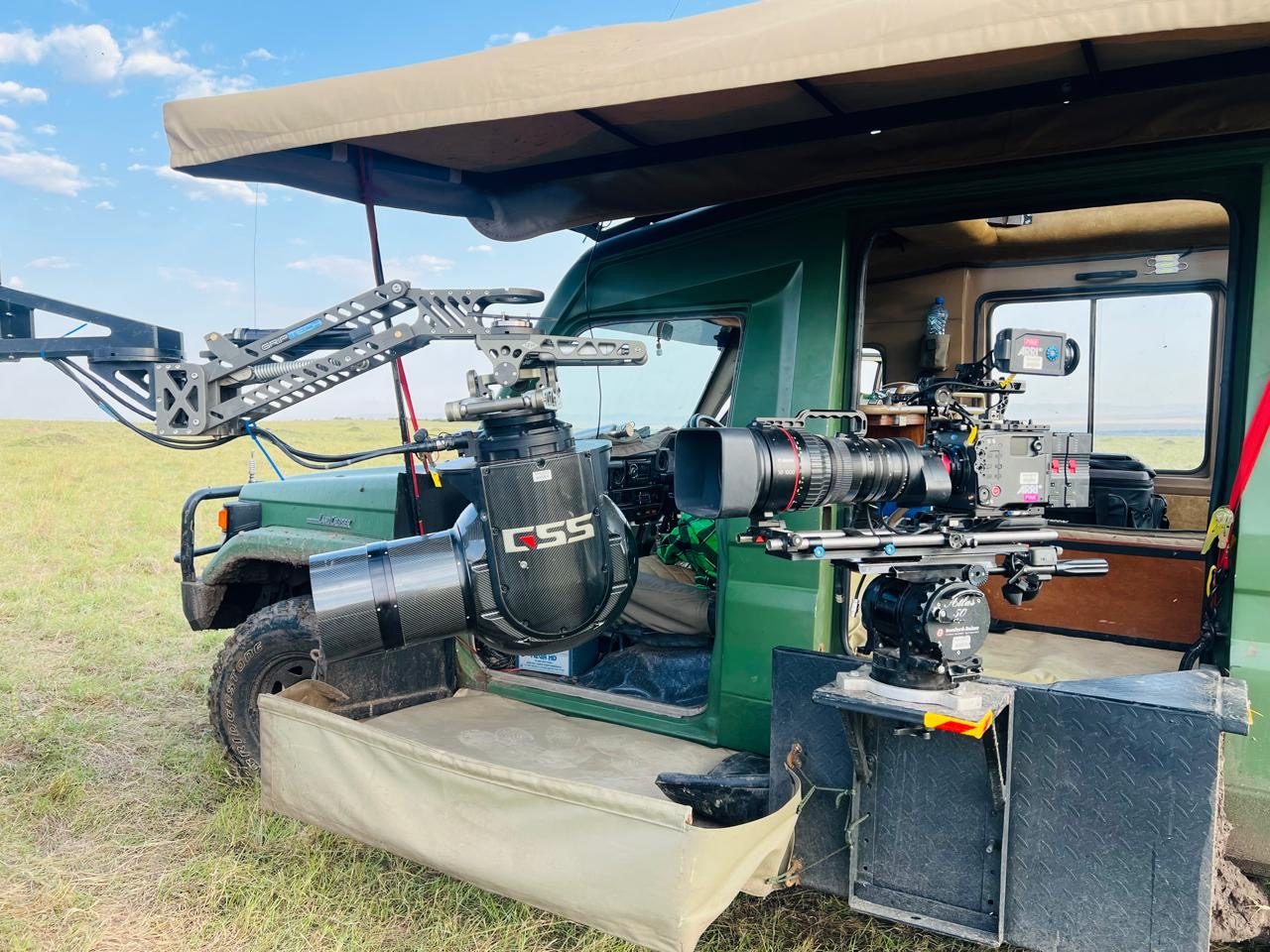 Wildlife camera car with GSS gimbal rigged on the arm, monitor and controls visible in the cab, Kenya