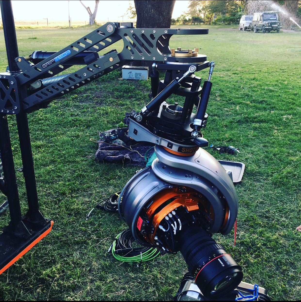 GSS gimbal with cinema camera on a jib arm, laid out on grass before mounting to the camera car