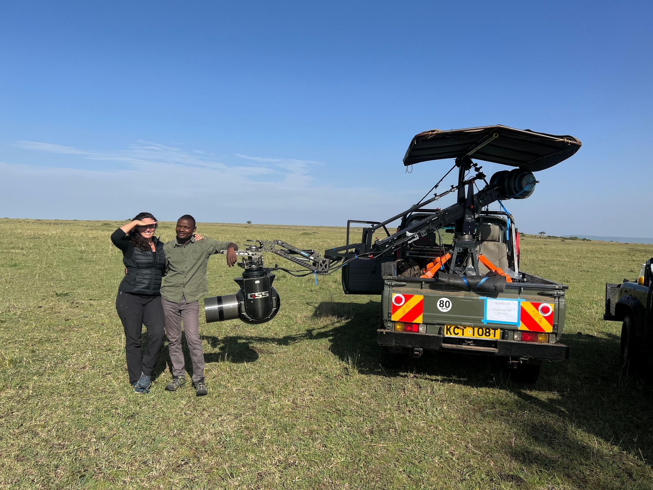 Wickliffe Odera, wildlife camera car driver, beside a natural history tracking vehicle with a GSS gimbal on a jib arm, Maasai Mara